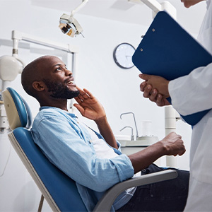 Smiling patient talking to dentist at appointment